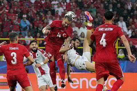 Turkey's and Georgia's players challenge for the ball